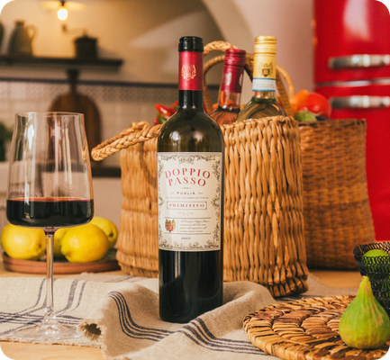 A bottle of Doppio Passo Primitivo with appetisers and rustic baskets.