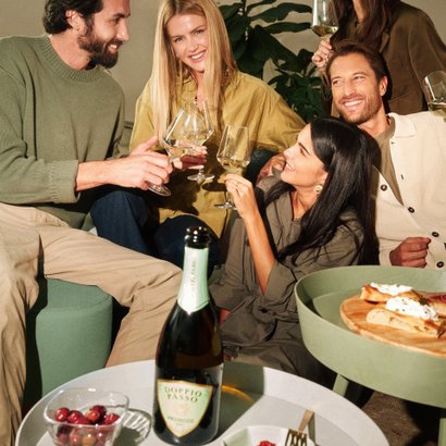 People toasting with Prosecco Doppio Passo in an elegant setting.